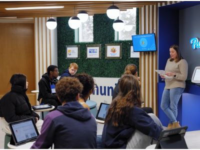 Volunteer with students in JA Finance Park