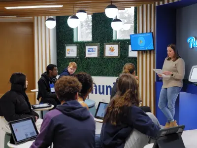 Volunteer with students in JA Finance Park